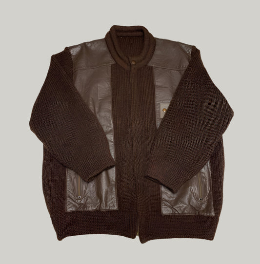 Brown knitted cardigan with leather sleeves and back on a light background