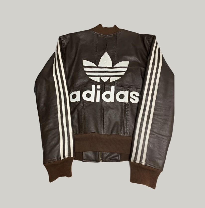 Brown leather jacket with Adidas logo on a white background