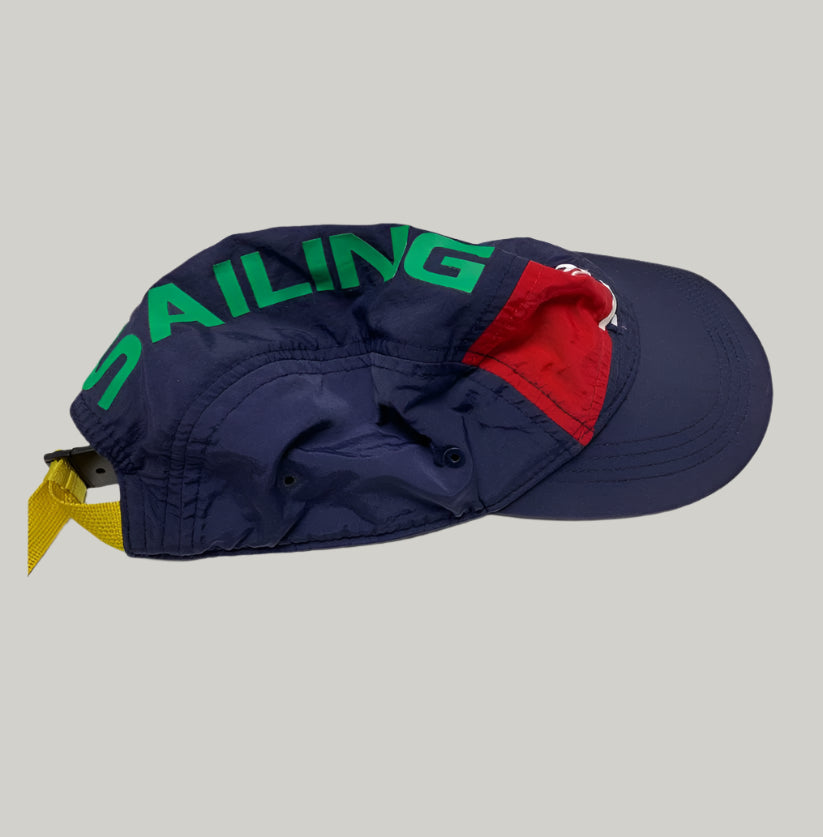 Navy blue cap with green text and red interior on a white surface