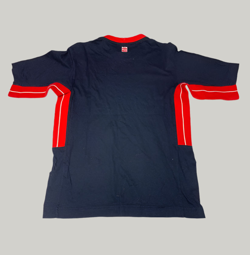 Navy blue t-shirt with red accents on a light gray background