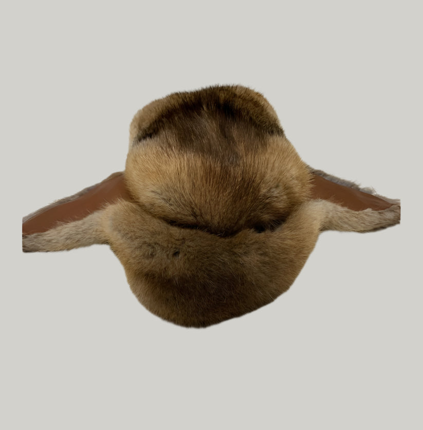 Brown fur item on a light gray surface
