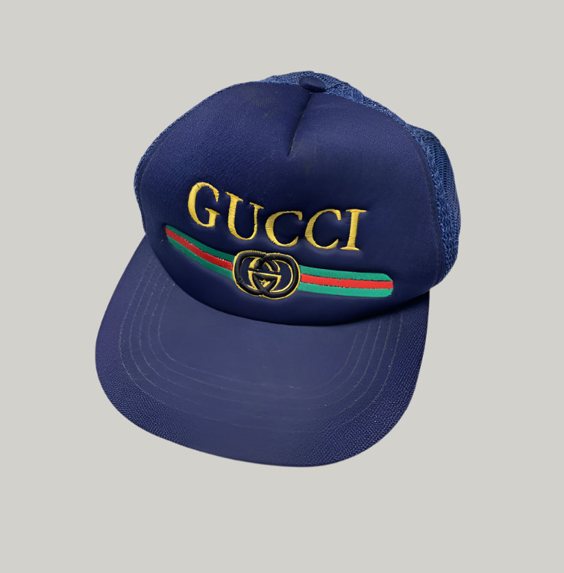 Blue Gucci cap with embroidered logo on a white background
