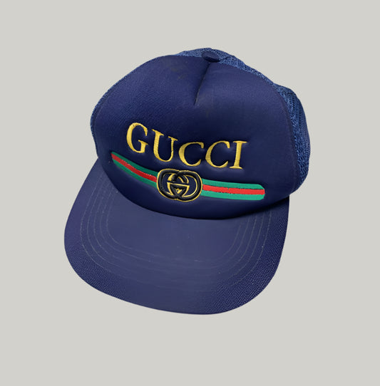Blue Gucci cap with embroidered logo on a white background