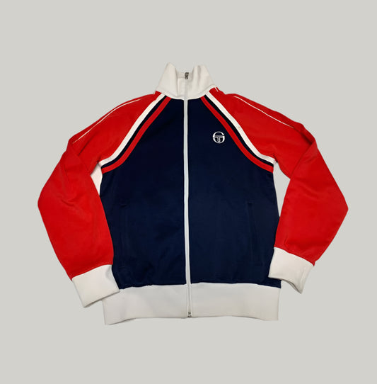 Red, blue, and white tracksuit jacket on a light gray background