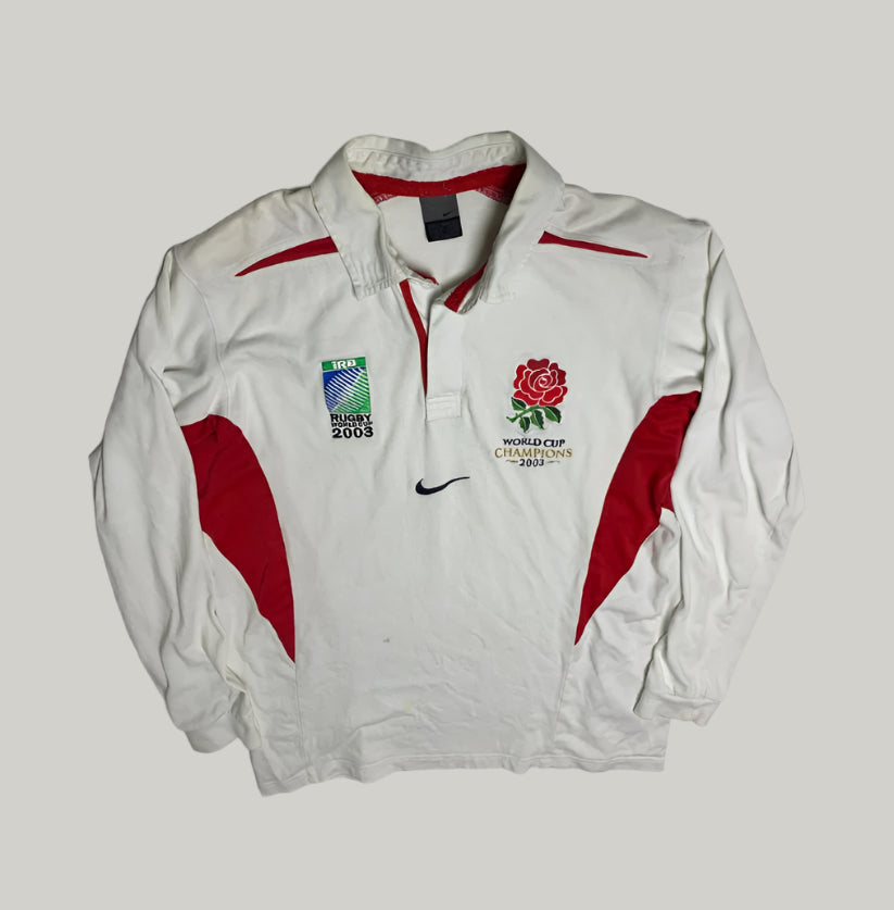 White jacket with red accents featuring rugby and World Cup 2003 logos on a light gray background.
