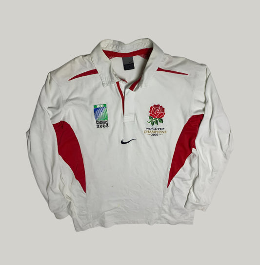 White jacket with red accents featuring rugby and World Cup 2003 logos on a light gray background.