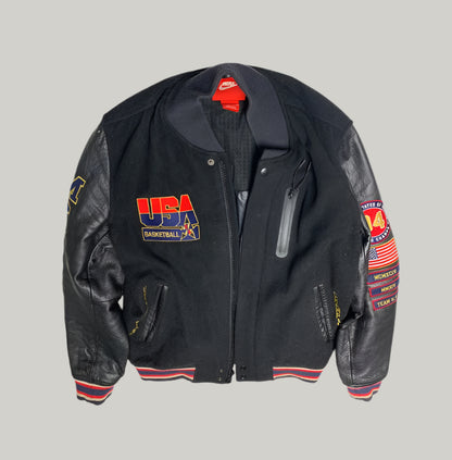 Black jacket with USA Basketball logo and patches on a light gray background