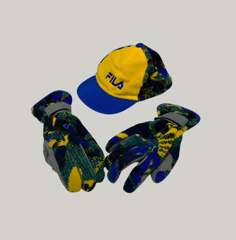 Fila cap and gloves set on a light gray floor