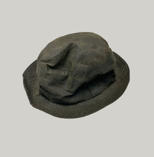 Dark green bucket hat on a light gray background