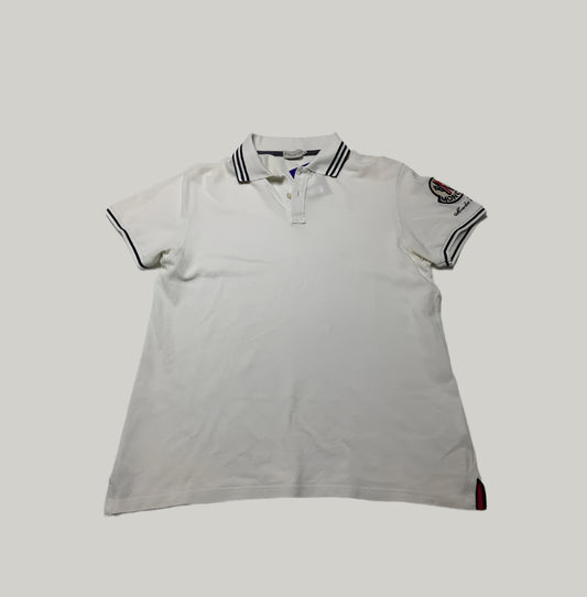 White polo shirt with black trim on a light gray background