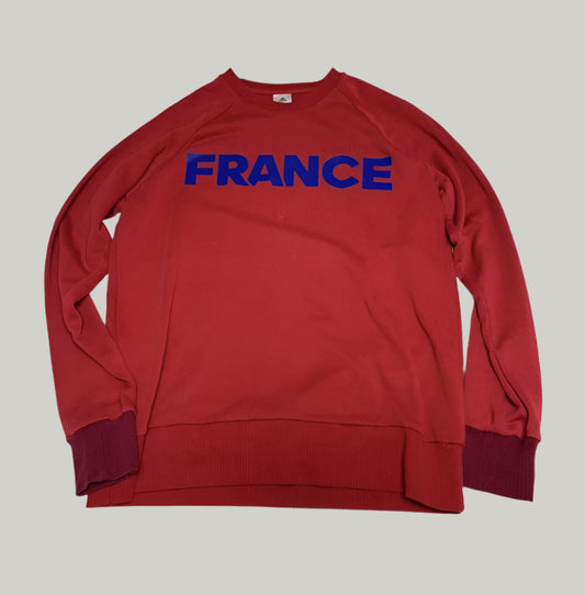 Red sweatshirt with 'FRANCE' printed in blue on a white background