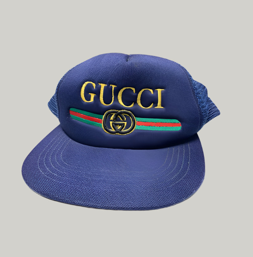Blue Gucci cap with logo on a white surface