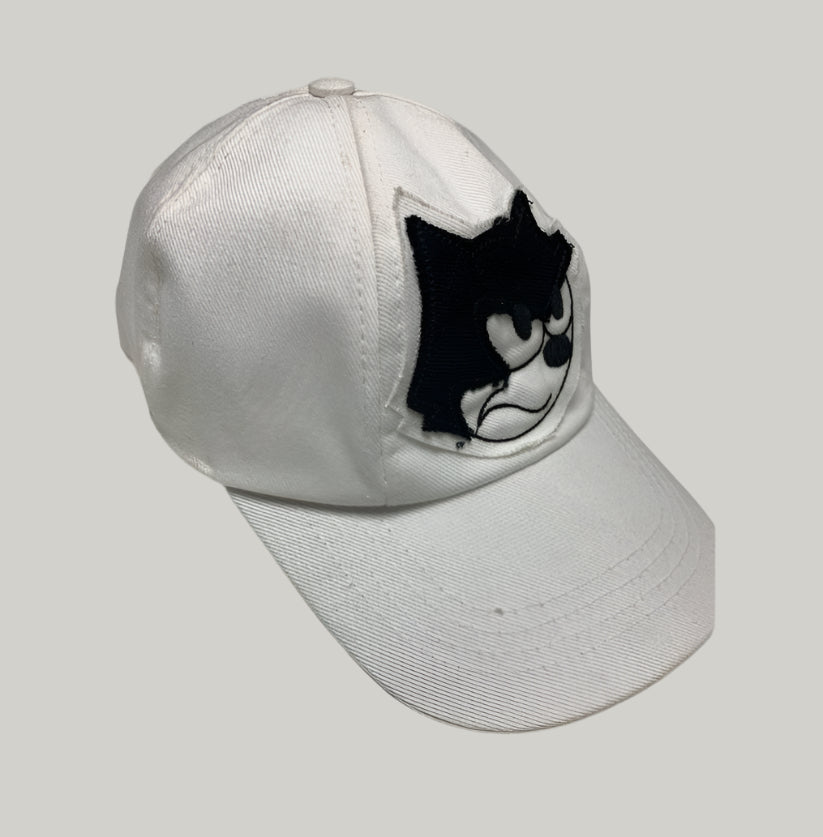 White cap with a black and white logo on a light gray background