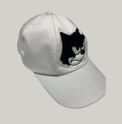 White cap with a black and white logo on a light gray background