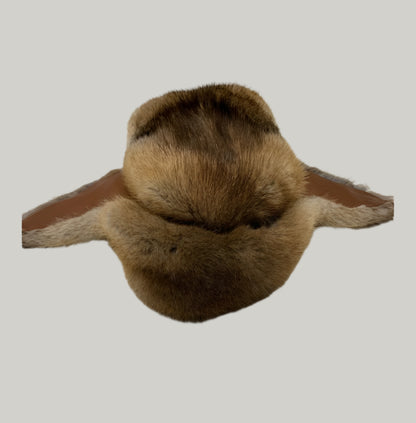 Brown fur item on a light gray surface