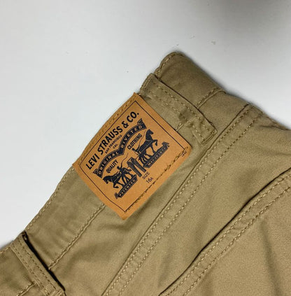 Levi's brand label on a beige pants back pocket against a white background