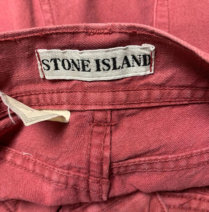 Close-up of a Stone Island label on a red garment.