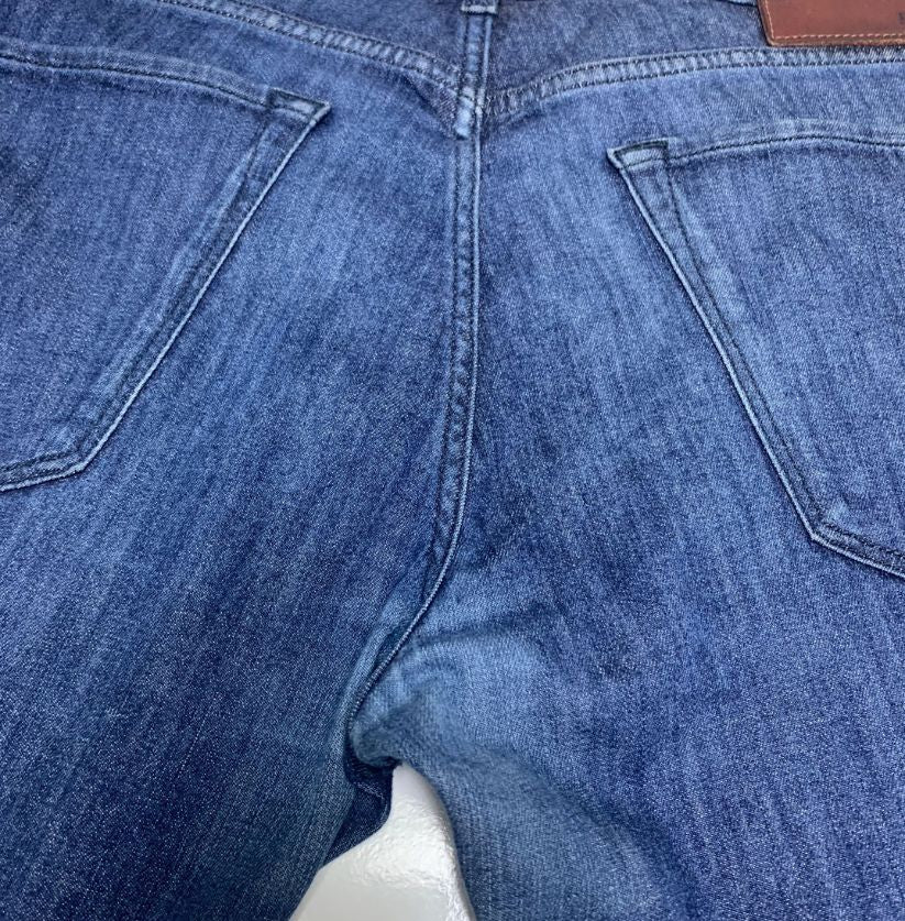 Close-up of blue jeans with a focus on the stitching and fabric texture.